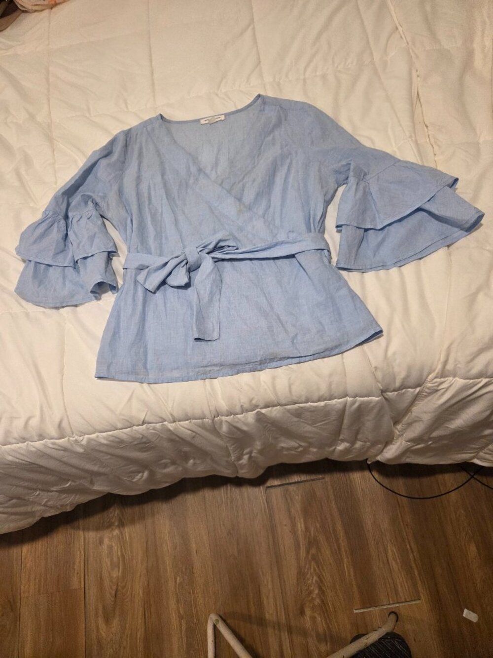 Blue faux wrap top with ruffled sleeves